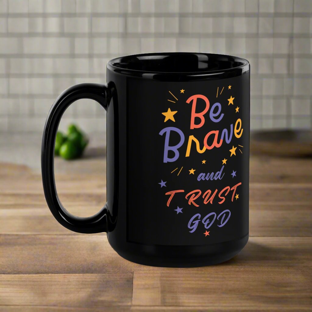 Close-up of flower design and 'Be Brave and Trust God' message on black glossy mug